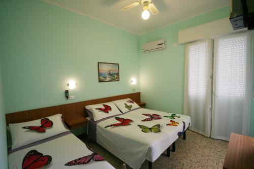 Postel nebo postele na pokoji v ubytování Hotel Amalfi