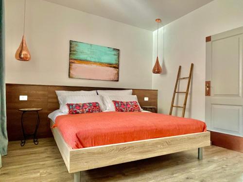 a bedroom with a bed and a painting on the wall at Happy Casa Oldtown Boutique in Koper