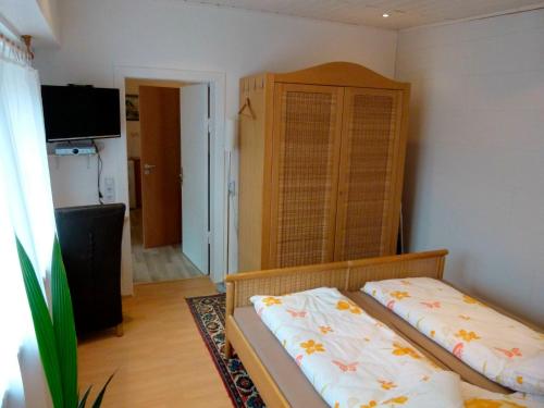 a bedroom with a bed and a dresser in it at Ferienwohnung Max 1 in Grube