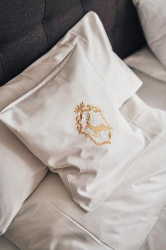 a white napkin with a horse embroidered on it at A-ROSA Ifen Hotel Kleinwalsertal in Hirschegg