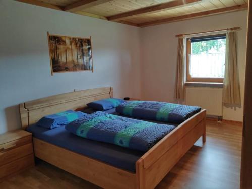 a bedroom with two beds with blue pillows at Sommerruhe in Titisee-Neustadt