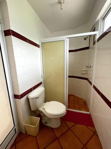 a bathroom with a toilet and a shower at HOTEL BUGAMBILIAS in Oaxaca City