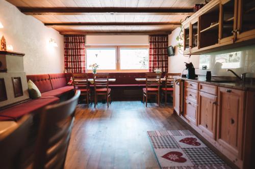a kitchen and dining room with a couch and a table at SennHOF Lechtal in Bach