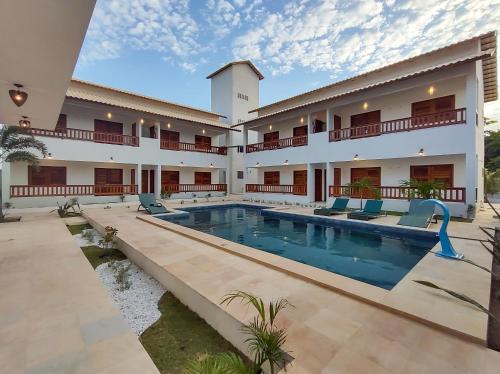 a view of the courtyard of a hotel with a swimming pool at Pousada Brisas in Jijoca de Jericoacoara