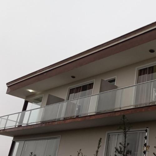 a balcony on the side of a building at Pousada Floresta in Joinville