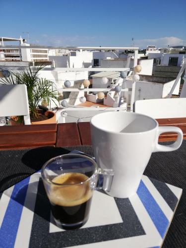 a cup of coffee sitting on a table with a view at Casa Paixanita - jacuzzi & terrace downtown Olhao in Olhão