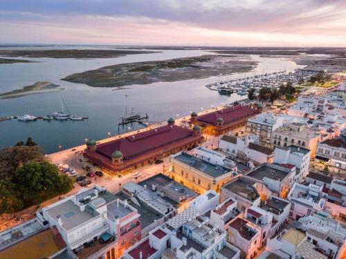 an aerial view of a city with a harbor at Casa Paixanita - jacuzzi & terrace downtown Olhao in Olhão