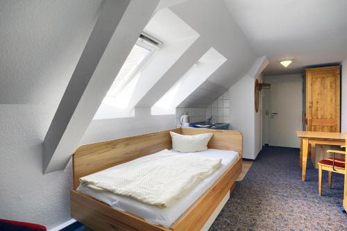 a bedroom with a wooden bed in a attic at Altes Wasserwerk, App 5 in Zingst