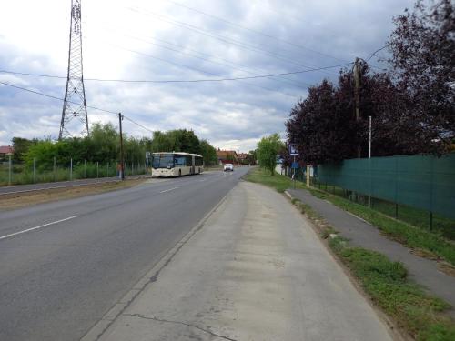 a bus driving down a road with a bus at Fancsika Vendégház in Debrecen