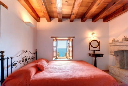 a bedroom with a bed and a fireplace at Malvasia Traditional Hotel in Monemvasia