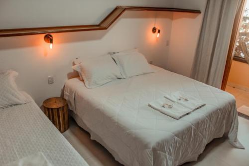a bedroom with a bed with two towels on it at Pousada Quintal da Lua in Capitólio