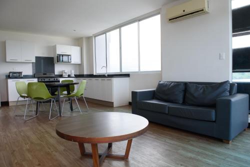 a living room with a couch and a table at Puerto Azul Hotel in Puntarenas