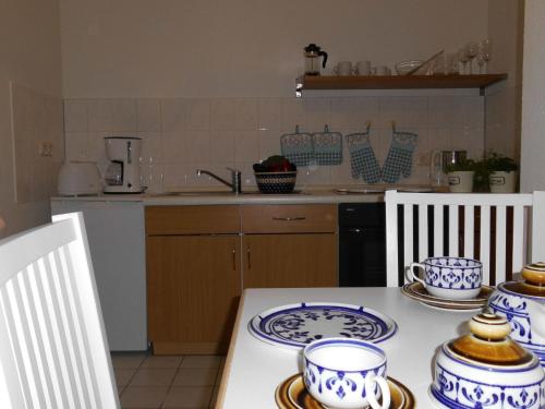 a kitchen with blue and white dishes on a table at Ferienwohnung "Im Pfarrhaus Marlow" in Marlow