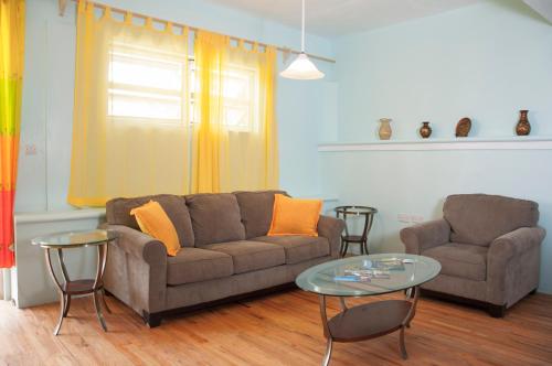 a living room with a couch and a table at Diamond View Cottages in Roseau
