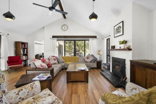 a living room with a couch and a fireplace at Killior'ra in Berambing