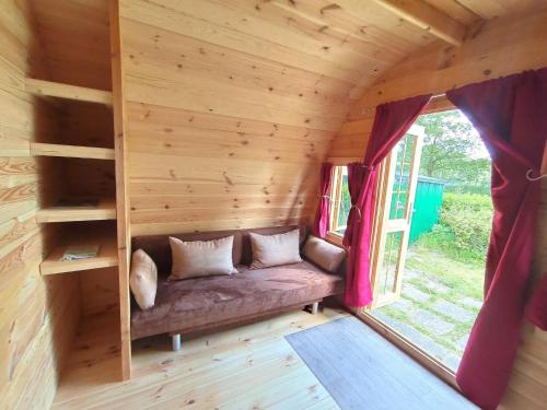 a couch in the inside of a tiny house at Glamping POD in Wittenborn