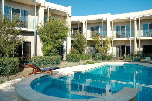 a swimming pool in front of a building at Rye Hotel - One Four Nelson in Rye