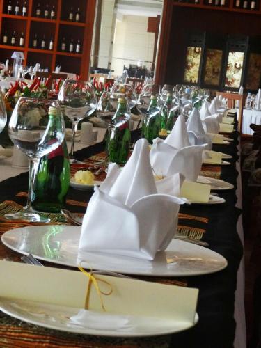 a long table with plates of food and wine glasses at Landmark Mekong Riverside Hotel in Vientiane