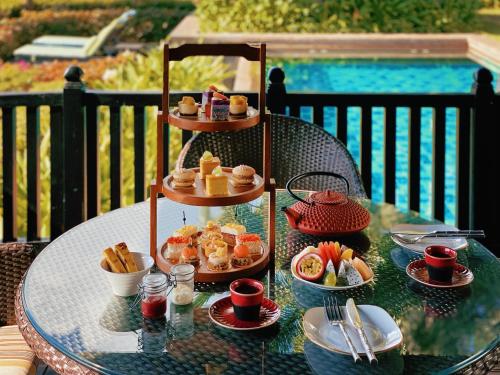 a table with a tray of food on top of it at Mandarin Oriental, Sanya in Sanya