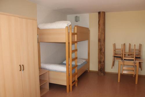 a room with two bunk beds and a table at Ferienwohnung 4 Struven Hus in Lehe
