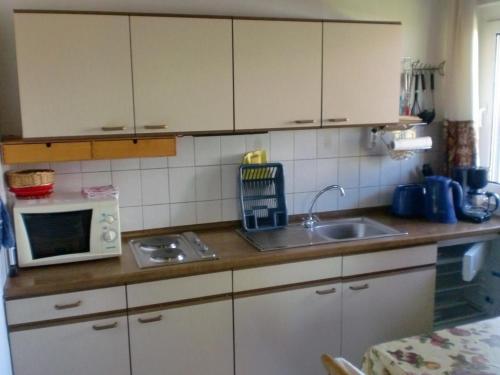 a kitchen with a sink and a microwave at Ostseebrise 2 in Zingst