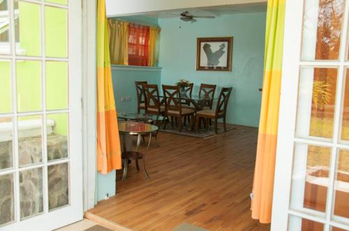 a room with a table and chairs and a dining room at Diamond View Cottages in Roseau