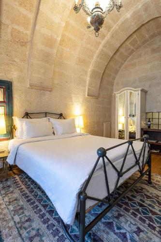 Ένα ή περισσότερα κρεβάτια σε δωμάτιο στο Exedra Cappadocia