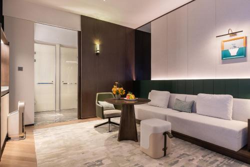 a living room with a couch and a table at Novotel Xian Xixian in Xi'an