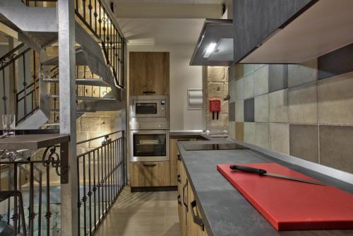 a kitchen with a red chopping board on a counter at Chateau La Vallette - Grand Harbour Suite in Valletta
