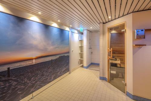 a hallway with a large painting of the beach at Strandhotel Seeblick 66 in Dahme
