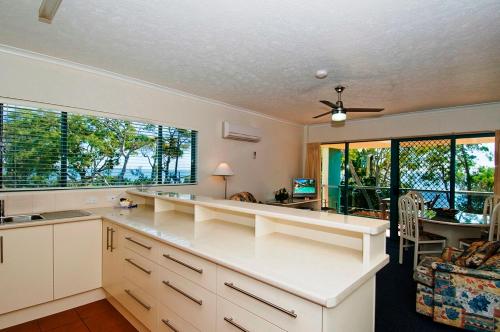 a kitchen with a large window and a counter top at Shelly Bay Resort in Hervey Bay