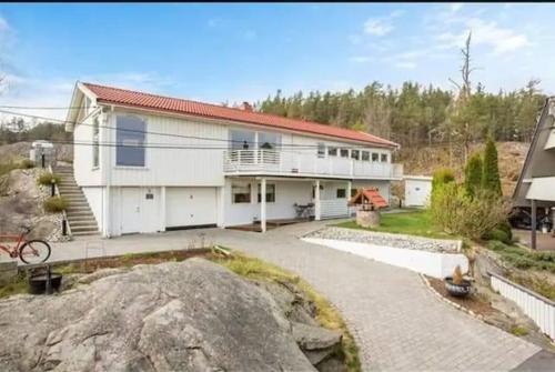 a white house with a red roof at Nice double bed room in Moss in Moss
