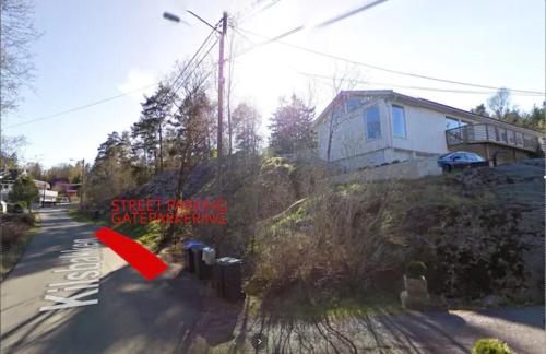 a house on the side of a road with a red object at Nice double bed room in Moss in Moss