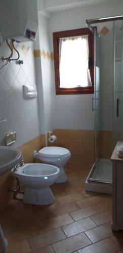 a bathroom with a toilet and a sink and a shower at Casa Lucia Campagna Relax in Dorgali
