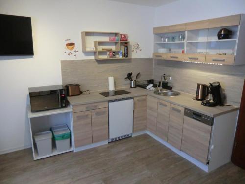 a small kitchen with a sink and a microwave at Apartment in Abstatt mit 5min zur A81 in Abstatt