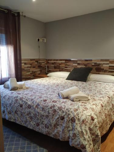 a bedroom with a bed with two pillows on it at Apartamentos Deluxe Barajas in Madrid