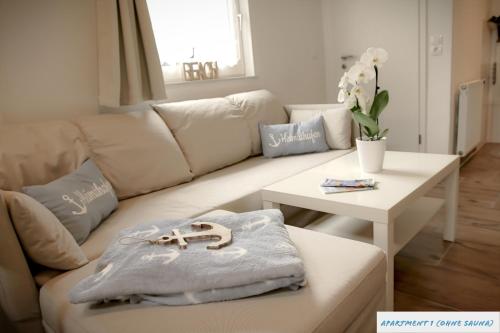 sala de estar con sofá blanco y mesa en Tolles Studio Apartment in Tossens für junge Paare, en Tossens