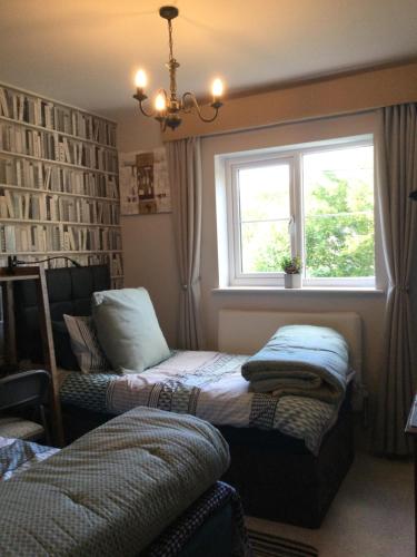 two beds in a room with a window at Woodbriar in Penmaen-mawr