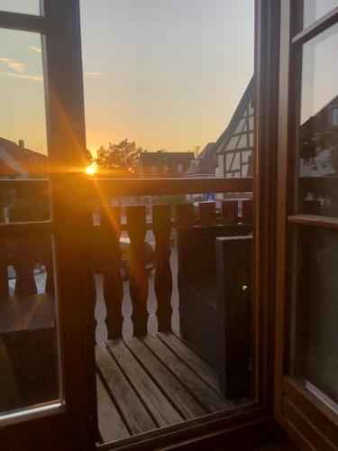 a view of the sunset from a balcony at Ferienwohnung Sonne in Schliengen