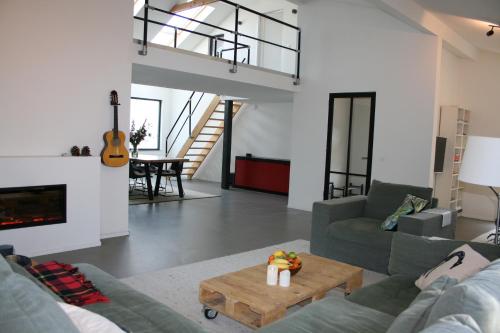 a living room with a couch and a table at Luxe vakantiehuis met sauna De Barn Bergen in Bergen
