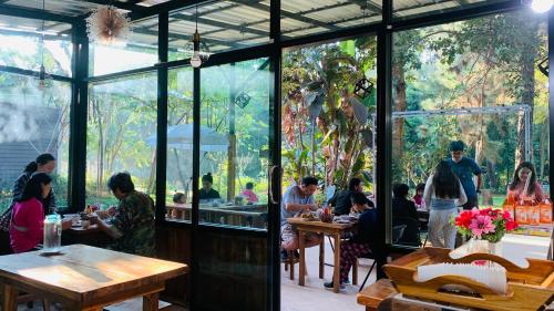 a group of people sitting at tables in a restaurant at Sonseesaed Farm at Phurua in Phu Ruea