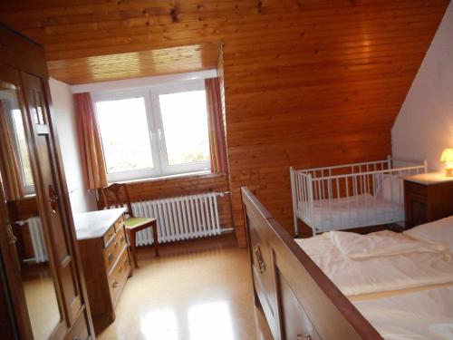 a bedroom with two beds and a window at Ferienhof Bisdorf "Steilküste" in Bisdorf