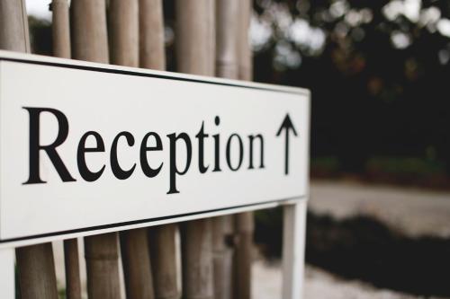 a white sign with the word reception on it at Brooklands Of Mornington in Mornington