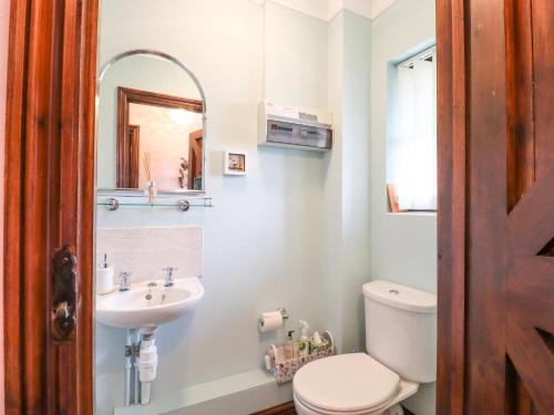 a bathroom with a toilet and a sink at 1 The Gardens in Stowmarket