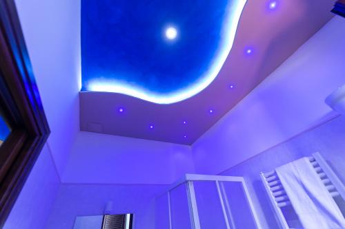 a bathroom with a ceiling with a painting of a moon at Pompei Luxury Rooms in Pompei