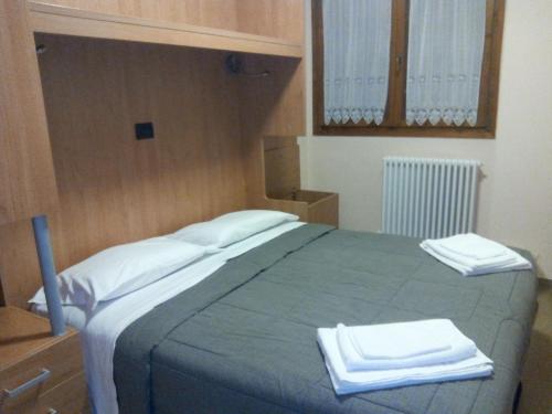 Кровать или кровати в номере Casa Alpina Sacro Cuore