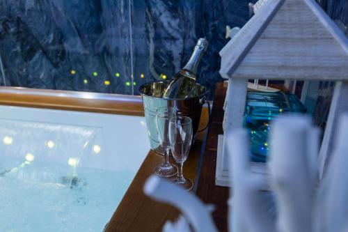 a bottle of champagne in a bucket on a table at Pompei Luxury Rooms in Pompei