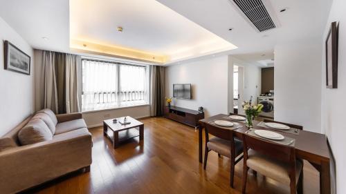 a living room with a couch and a table at Starr Hotel Shanghai (Shanghai Railway Station) in Shanghai