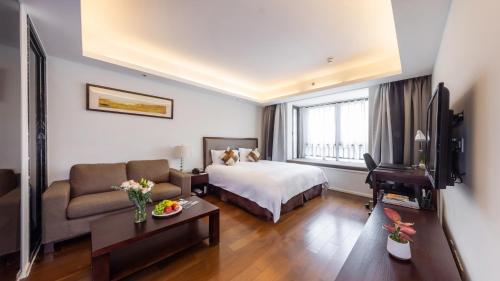 Postel nebo postele na pokoji v ubytování Starr Hotel Shanghai (Shanghai Railway Station)