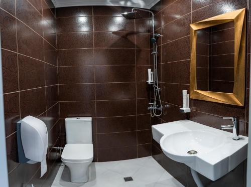 a bathroom with a toilet and a sink at Hotel CITY Petrich in Petrich
